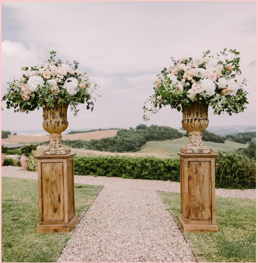 Garden path in the Italian hills, framed by floral urns