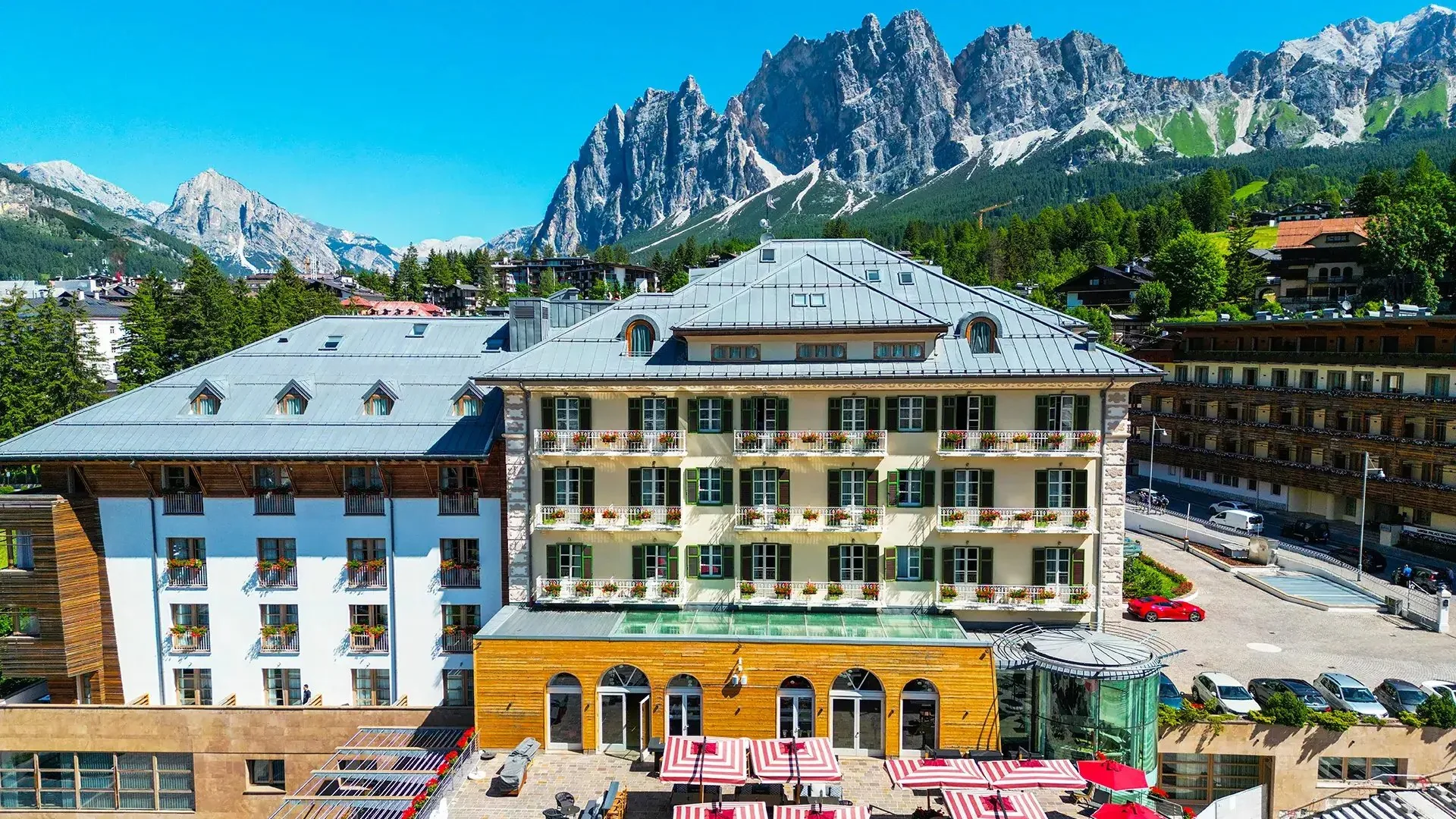 Grand Hotel Savoia Cortina in Cortina d’Ampezzo: the hotel façade, with the Dolomites behind the town